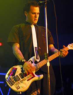 Benji Madden chews his tounge while playing.