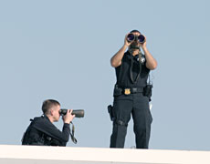 Security officers overlook the area during President Bush&acute;s presentation.