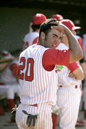 Kyle Morgan splashes water on his head after scoring a run against College of the Canyons.