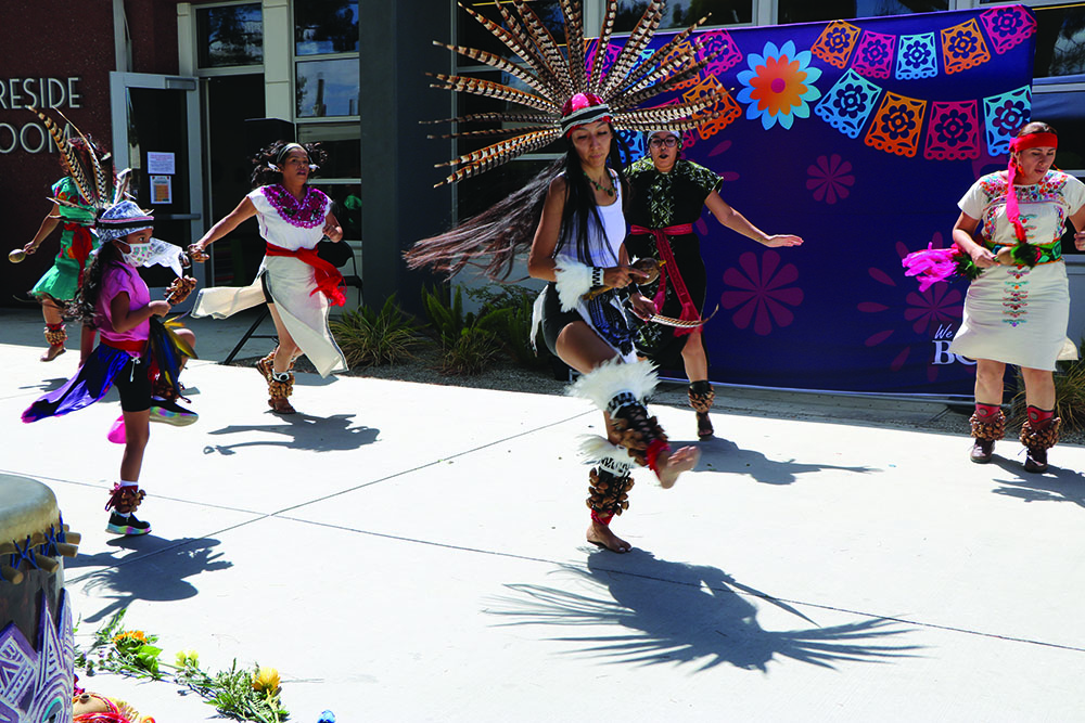 Aztec dancers doing their tribute dance to honor during Hispanic heritage month . 