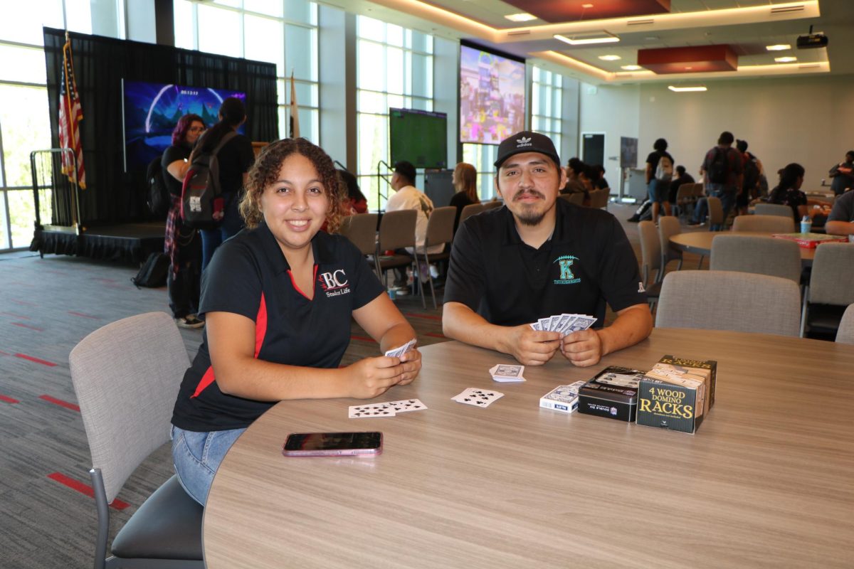 Jose Ramos President of the Pokémon Club on campus and Abigail Tamayo enjoying a game of cards. 