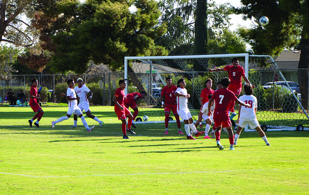 Jonathan Juarez player #5 BC defender jumps midair saving with a head pass preventing a goal from corner kick from Fresno.