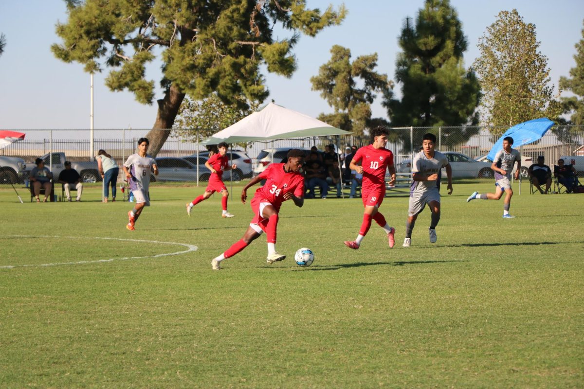 Anthony Gambe (34), Ricardo Morales (14), and Christopher Gandara (10) focusing on the game.