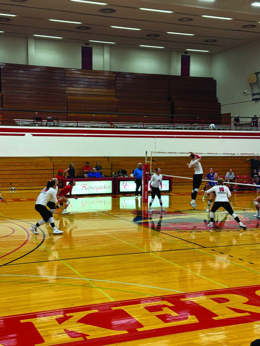 Alexandra Watts BC player #8 middle blocker hits  with a spike. 