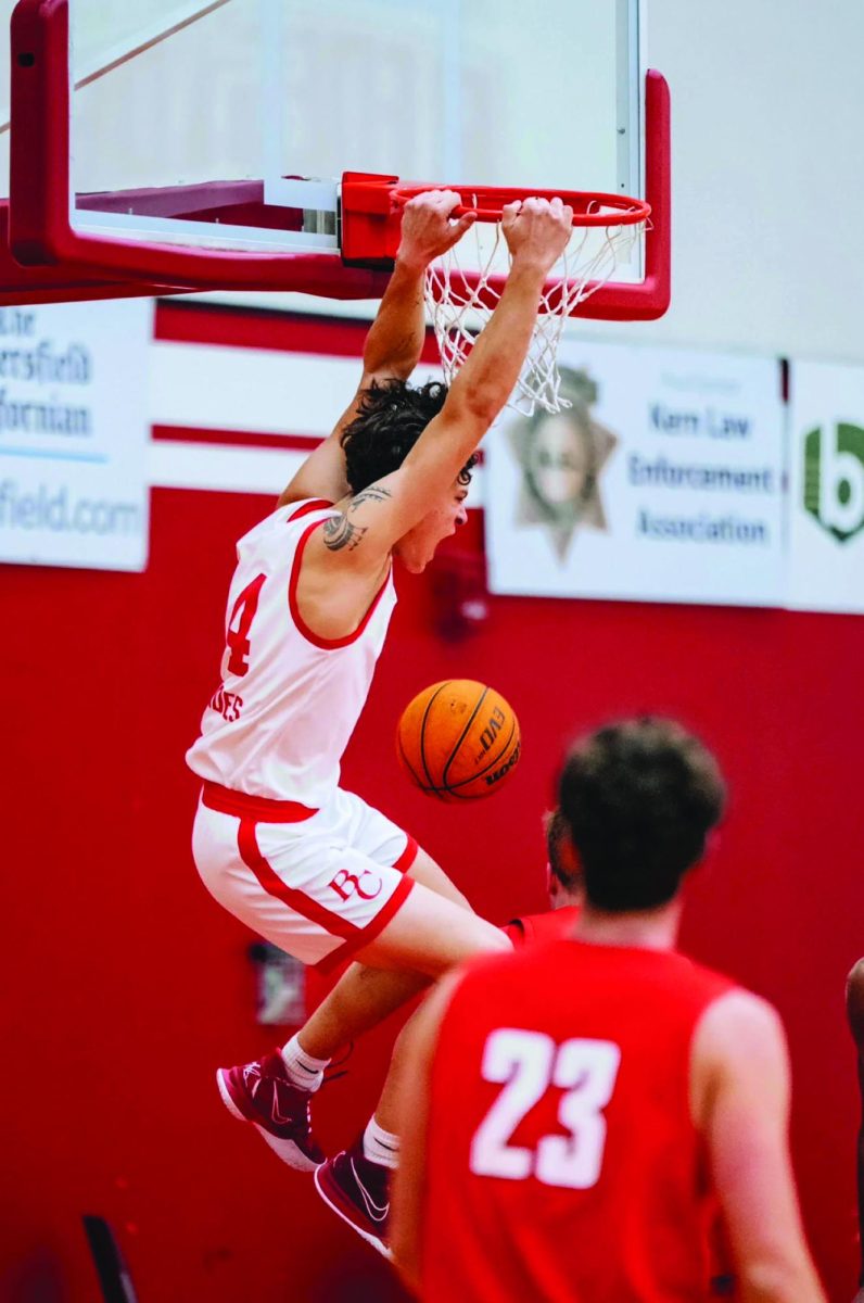 Ollie Fell (Forward,14) , hangs on the rim after an electrifying dunk on SBCC defender.