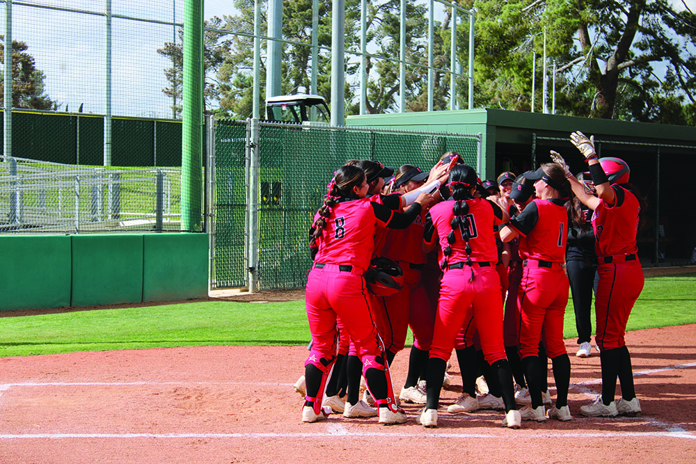 Teammates jumping for Cambria Scott (18) 3-run home run.