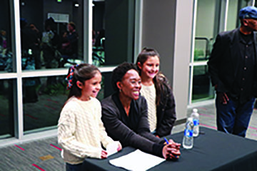 Margot Lee Shutterly takes a picture with two young girls who enjoyed the event.